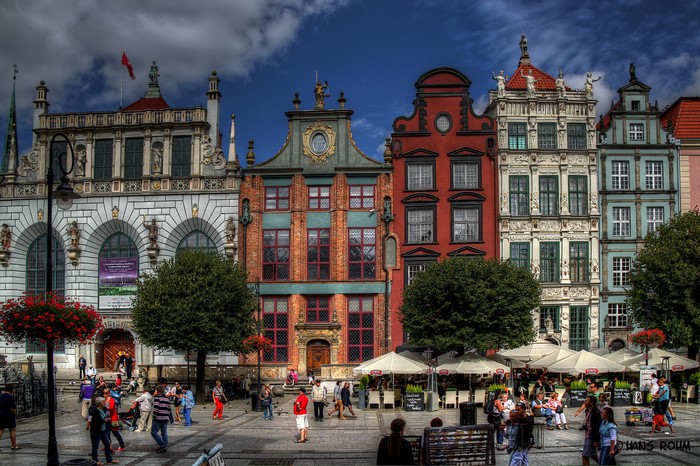 Colorful historic buildings and people in a European square