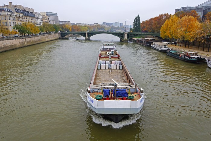 Barge on the Seine River in Paris with Autumn Trees