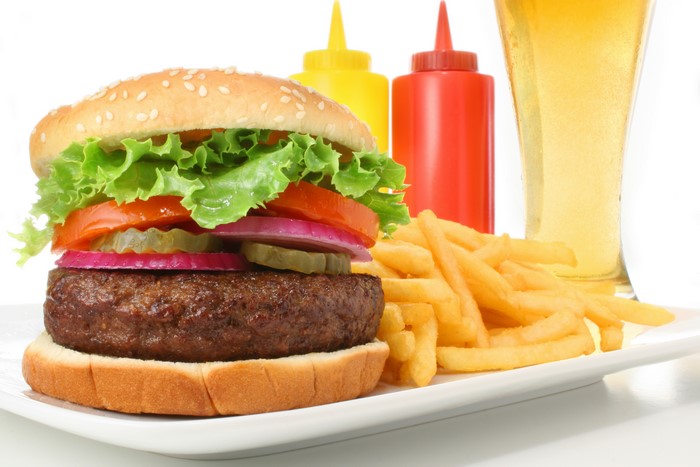 Hamburger, French fries, and beer with ketchup and mustard