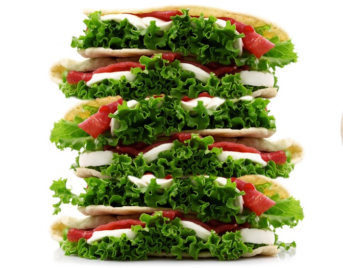 Stack of sandwiches with lettuce, cheese, and meat