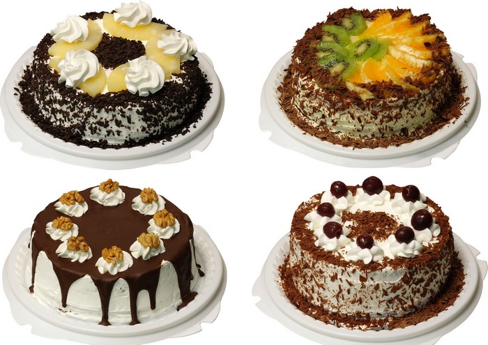 Four decorated cakes on white background