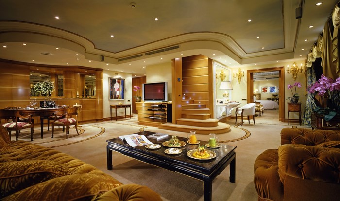 Luxurious living room with dining area and bedroom