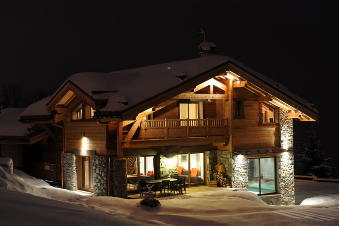 Luxury wooden chalet in Courchevel, France at night