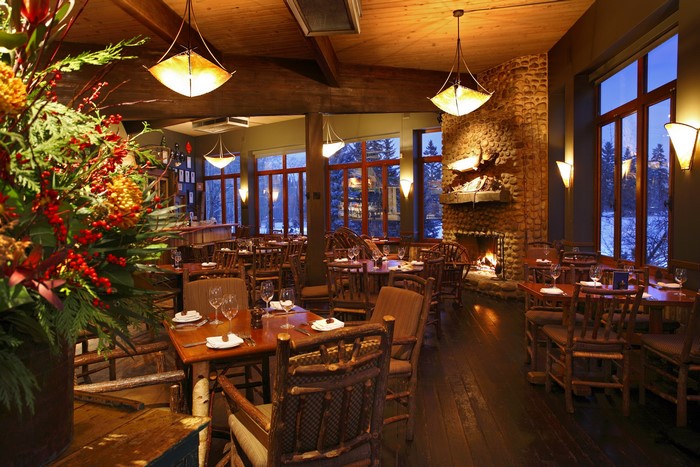 Cozy restaurant interior with fireplace and wooden furniture