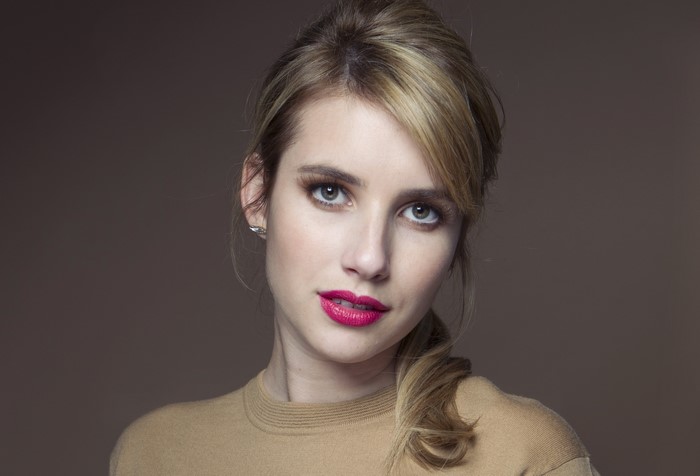 Emma Roberts with dark blonde hair and red lips