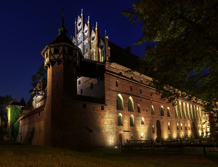Malbork Castle made of bricks at night in Poland