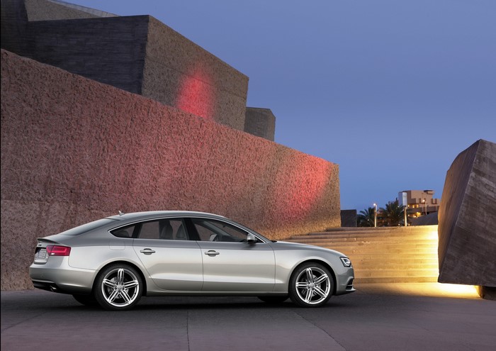Silver Audi A5 Sportback parked near modern architecture