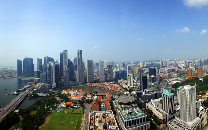 Singapore skyline with skyscrapers and a river from above