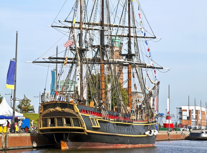 Tall ship with many masts in a harbor