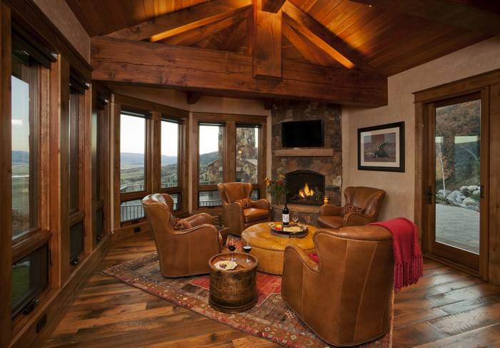 Rustic living room with leather armchairs and fireplace