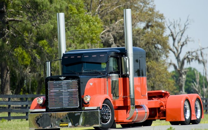 Orange and black Peterbilt truck with chrome details