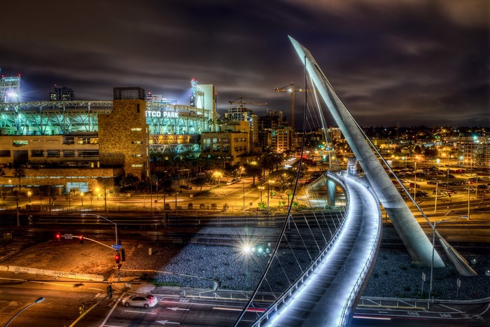 Petco Park and pedestrian bridge at night in San Diego