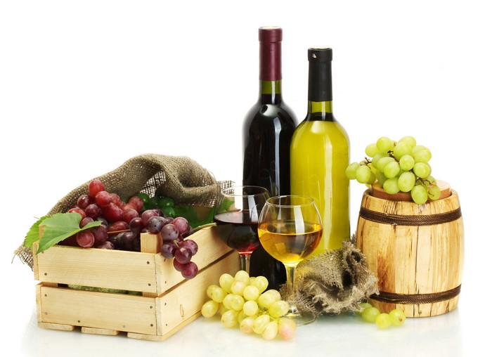 Still-life of wine bottles, grapes, and a barrel