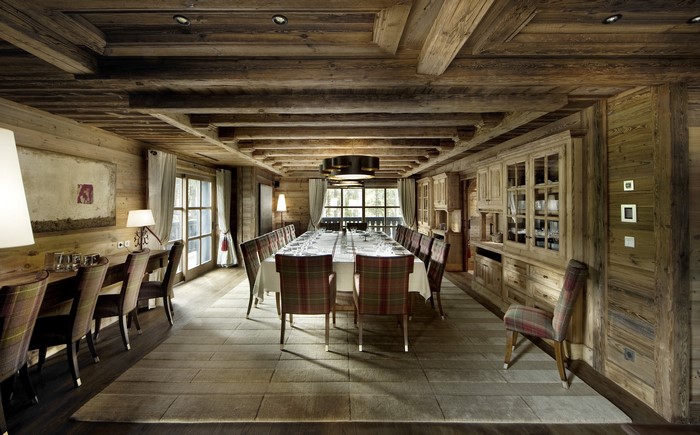 Rustic wooden dining room with long table and plaid chairs