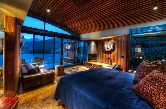 Bedroom with fireplace and lake view
