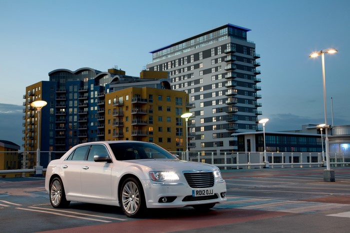 White 2012 Chrysler 300C parked near modern buildings