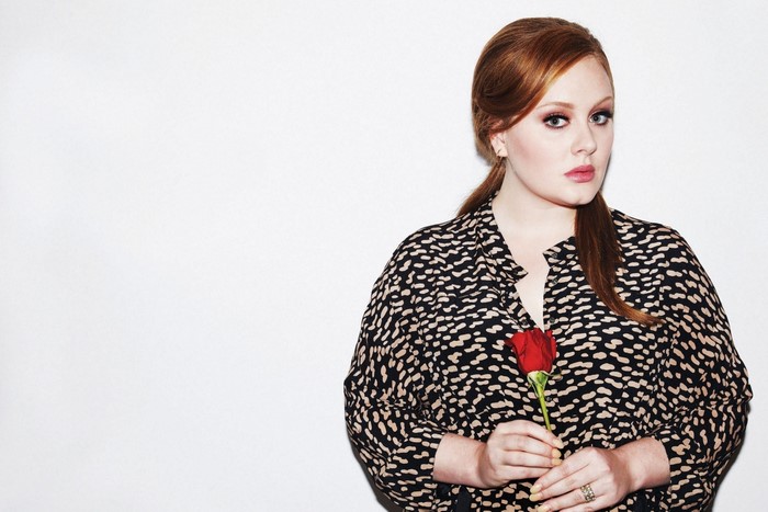 Adele holding a red rose