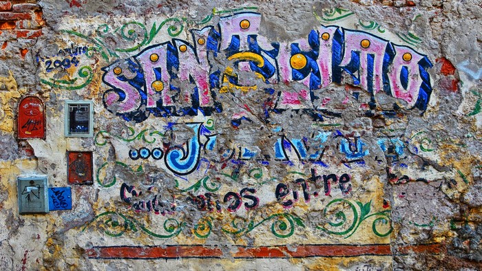 Graffiti on an old brick wall with ornate designs