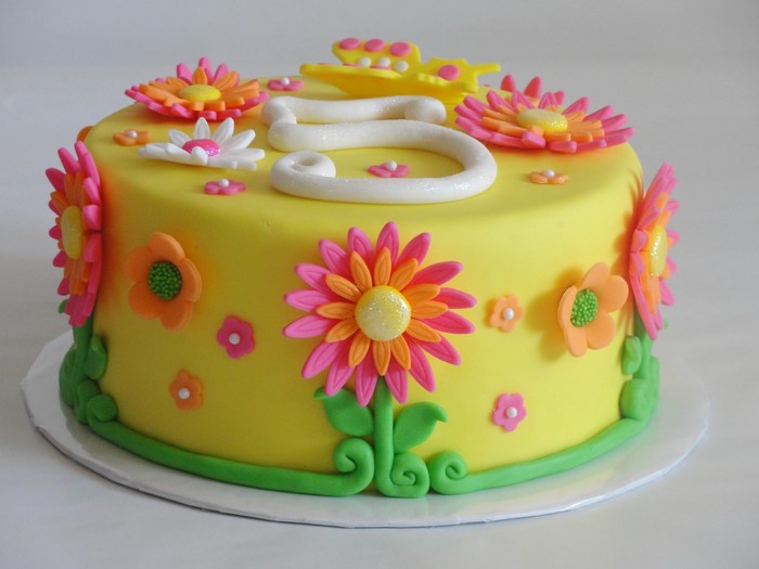 Yellow cake with fondant flowers and number 5