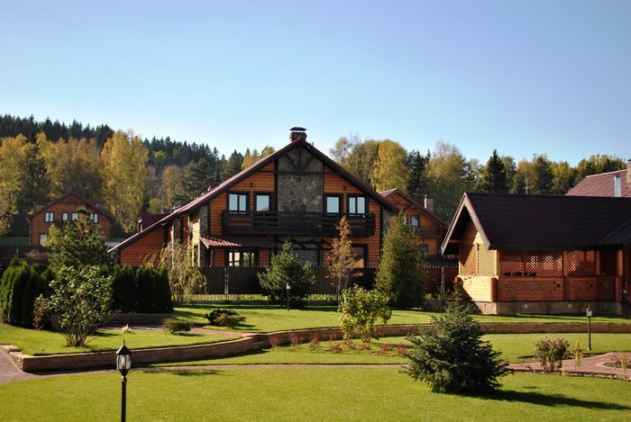 Wooden houses with manicured lawns and trees