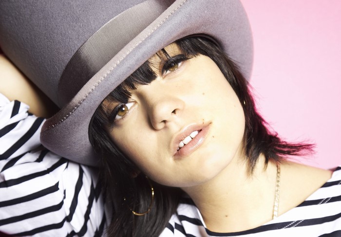 Lily Allen wearing a grey hat and striped shirt