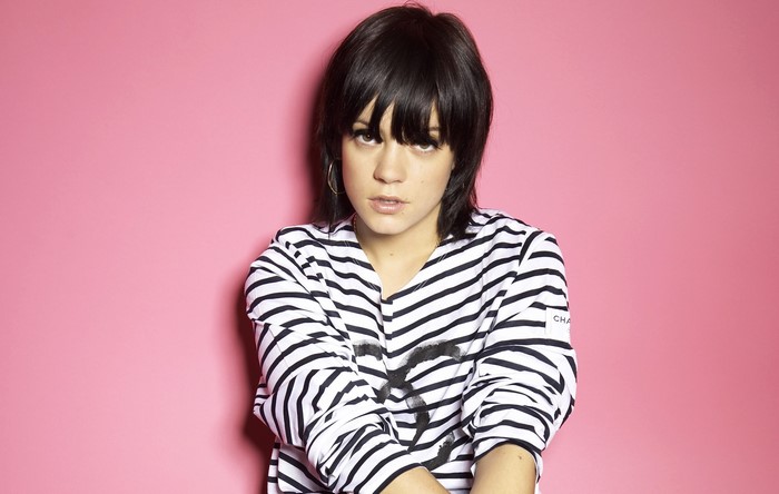 Lily Allen with black hair wearing striped shirt