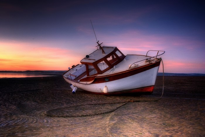 Boat on Sand During Sunset
