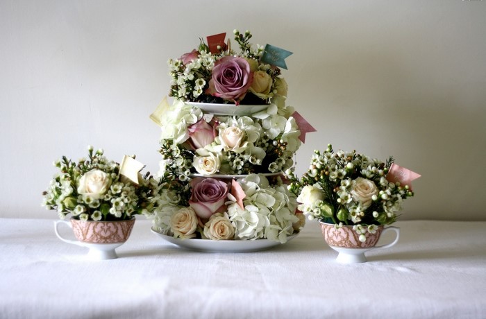 Tiered floral arrangement in teacups