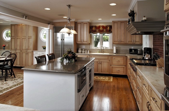 Kitchen with island, dining table, and stainless steel appliances