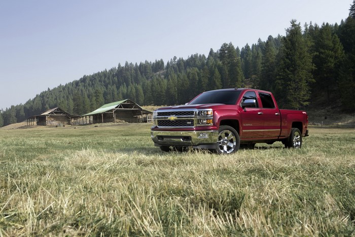 Red Chevrolet Silverado LTZ truck in a field