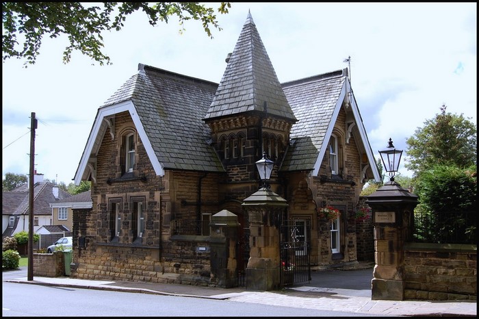 Stone house with a turret and lampposts