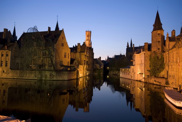 Bruges canal at night with historic buildings