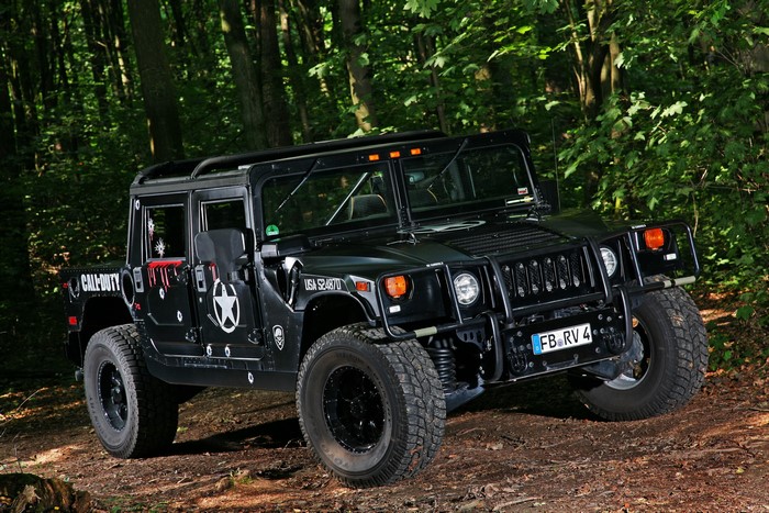 Black Hummer H1 with Call of Duty decals in forest