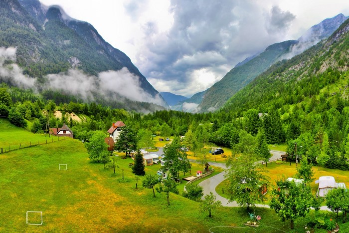 Camping in a valley in Bovec, Slovenia with mountains and clouds