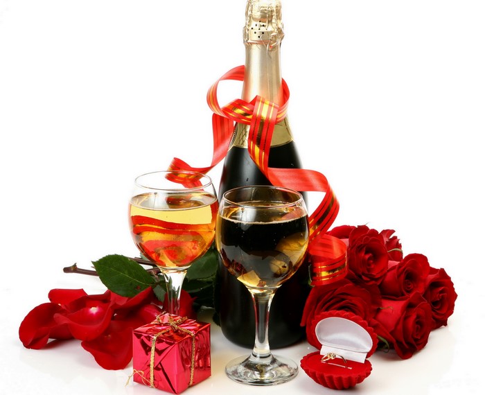 Champagne bottle, glasses, roses, gift, and ring