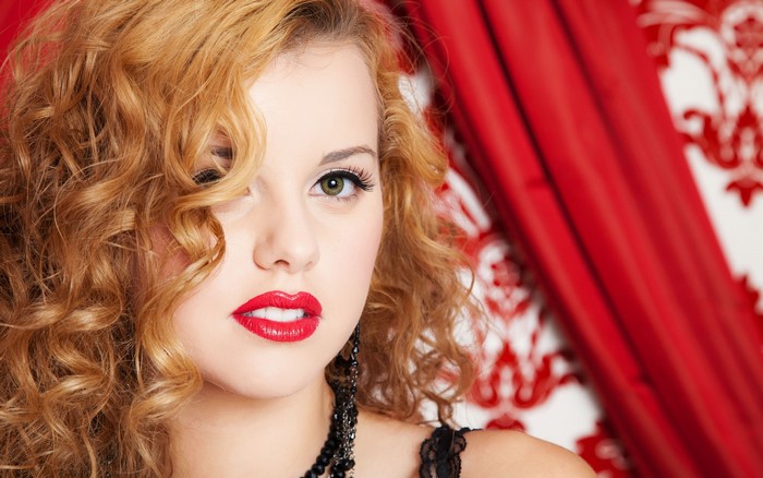 4K Close-up of Woman with Curly Hair and Red Lips