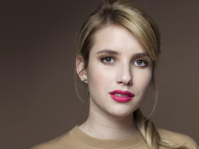 Emma Roberts with dark blonde hair and red lips