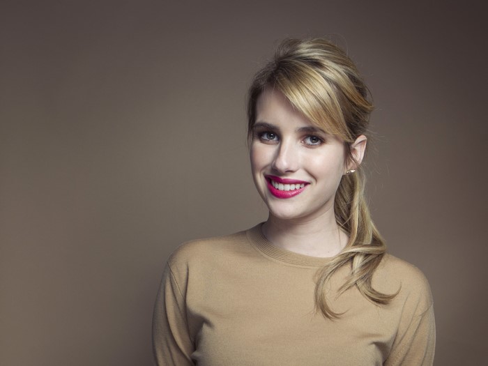 Emma Roberts smiling with dark blonde hair
