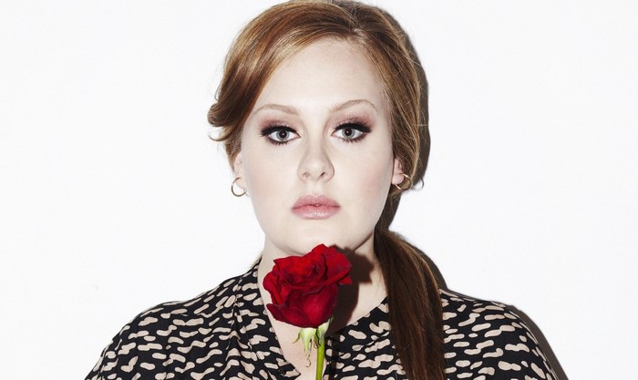 Adele holding a red rose