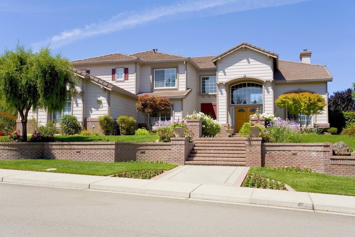 Large suburban house with landscaping and brick accents