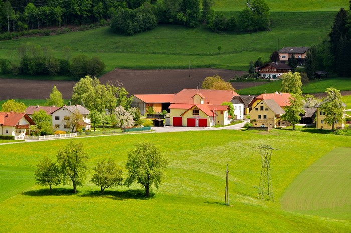 Austrian village with red-roofed houses and green hills