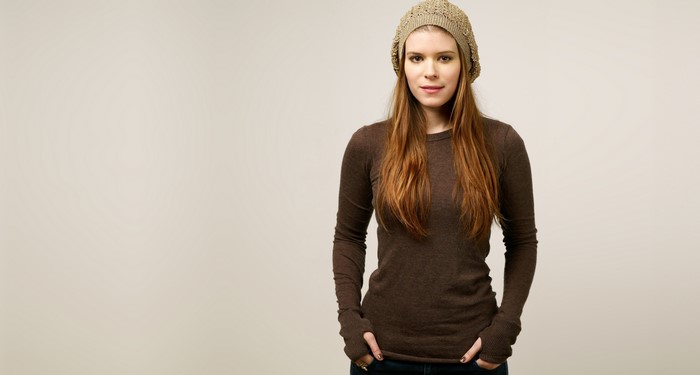 Kate Mara wearing a brown sweater and beanie