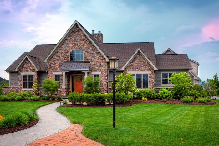 Stone and Shingle House with Landscaped Lawn