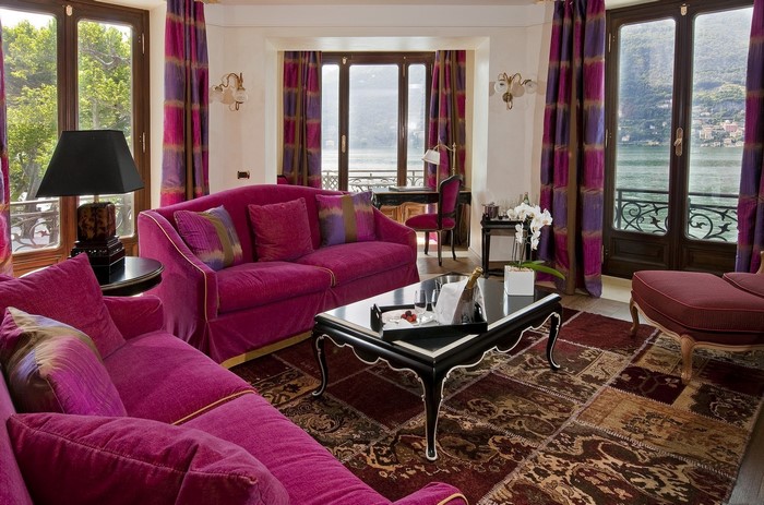 Living room with magenta sofas and lake view