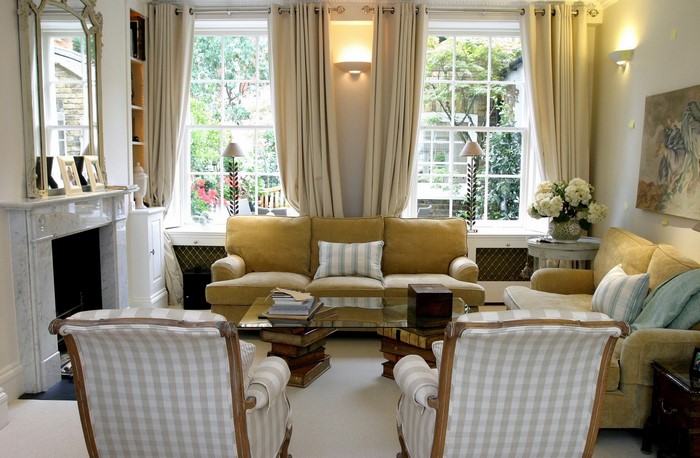 Living room with fireplace, sofa, and armchairs