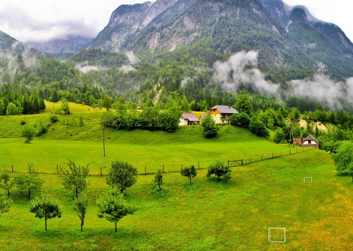 Green valley with houses and mountains in Bovec, Slovenia