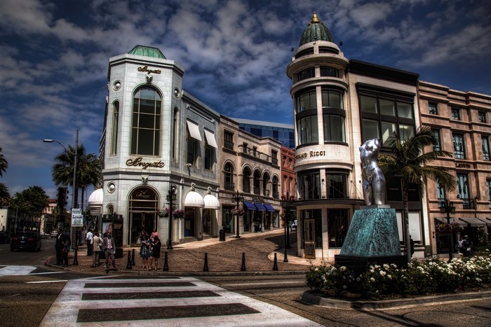 Beverly Hills street with luxury stores and statue
