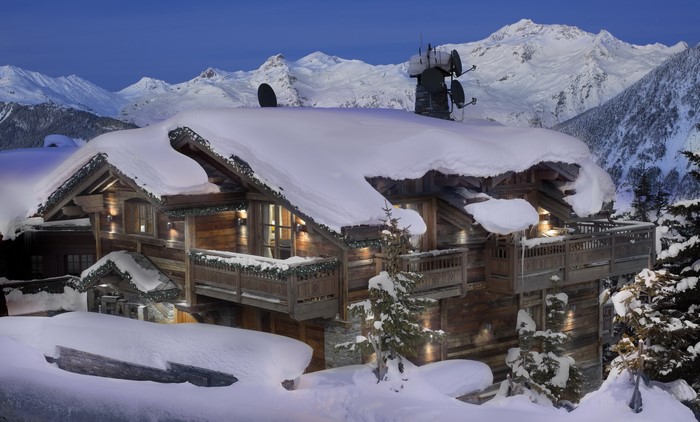 Wooden mansion covered in snow in the French Alps