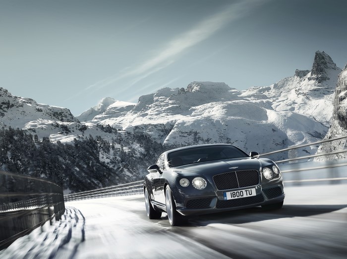 Bentley Continental GT V8 driving on a snowy mountain road