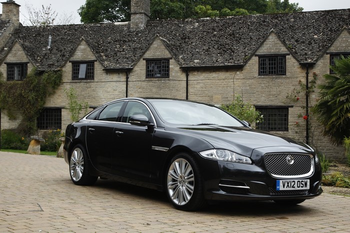 Black 2012 Jaguar XJ parked in front of a stone building